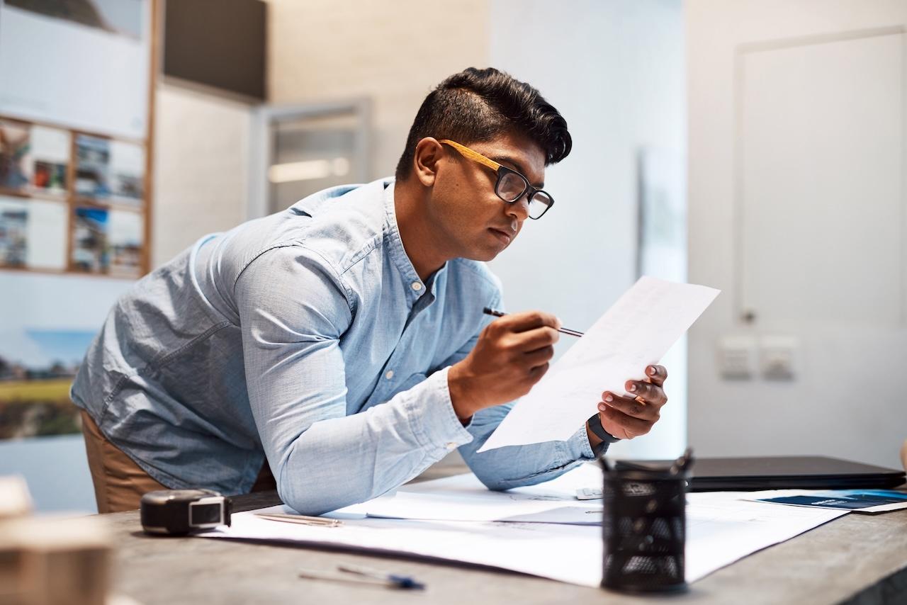 Business owner reviewing app development costs on paper
